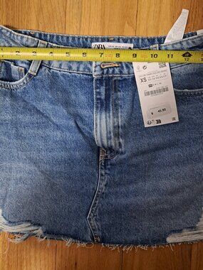 New Zara denim mini skirt in a light blue wash. This size XS garment is 100% cot